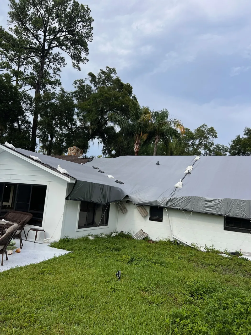 Emergency Storm Damage Roof Tarp | Sentinel Roofing Alachua, FL Emergency roof tarp protecting a storm-damaged roof before replacement by Sentinel Roofing in Alachua, FL