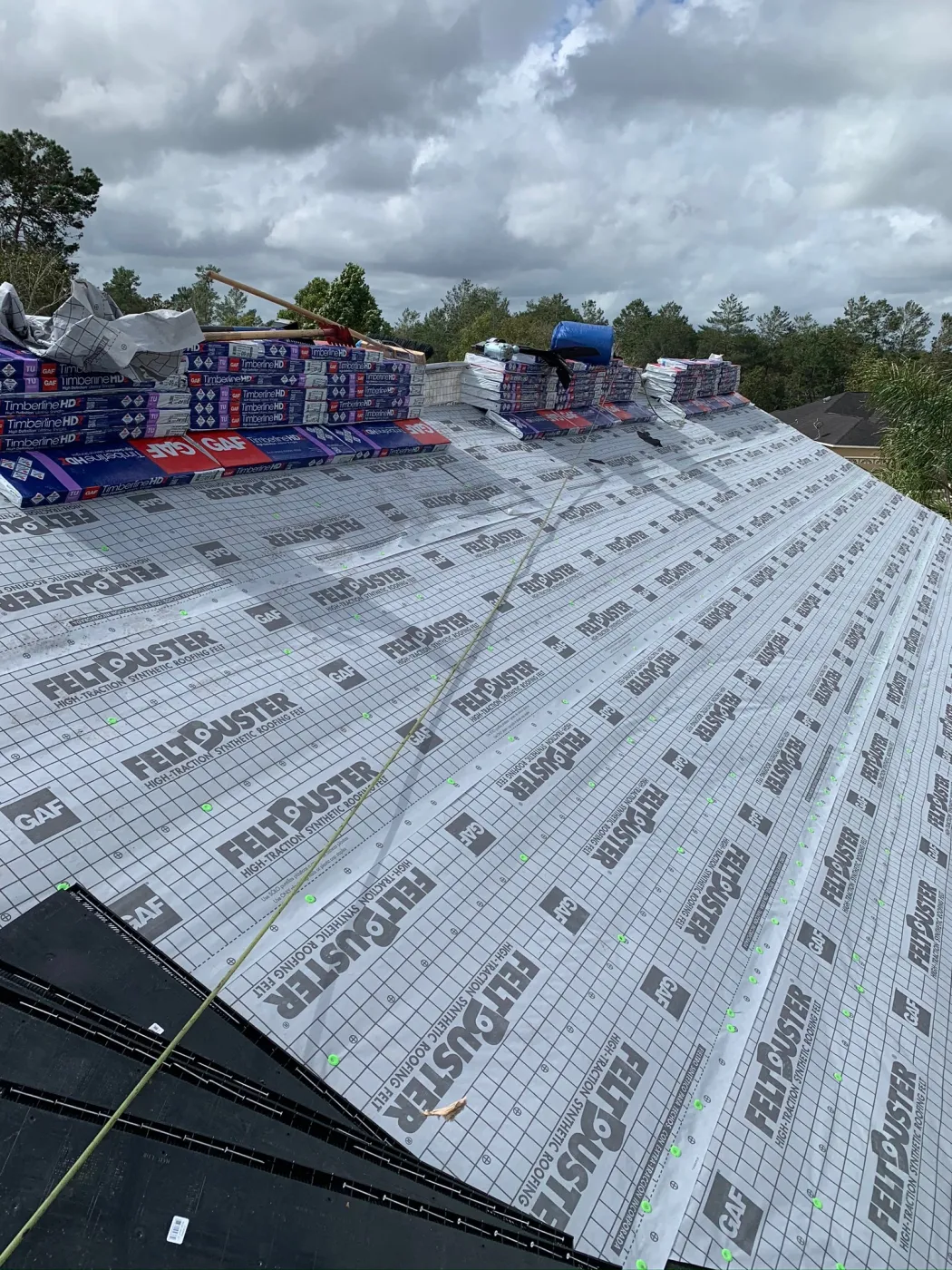 GAF FeltBuster Shingle Roof Installation | Sentinel Roofing Belleview, FL GAF FeltBuster underlayment and shingle roof installation with safety harness by Sentinel Roofing in Belleview, FL