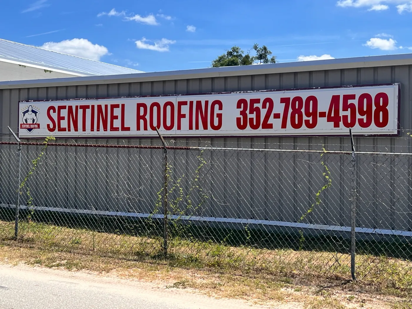 Sentinel Roofing Warehouse Sign | Belleview, FL Sentinel Roofing promotional warehouse sign with company phone number in Belleview, FL
