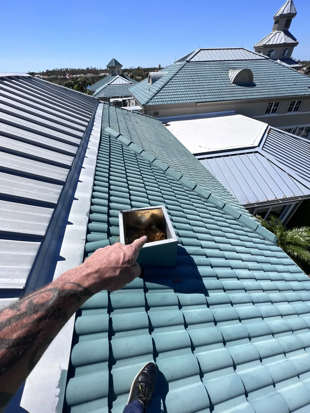 Commercial Storm Damage Roof Inspection | Sentinel Roofing Commercial roof inspection for storm damage involving concrete tile, standing seam metal, and roof vents by Sentinel Roofing