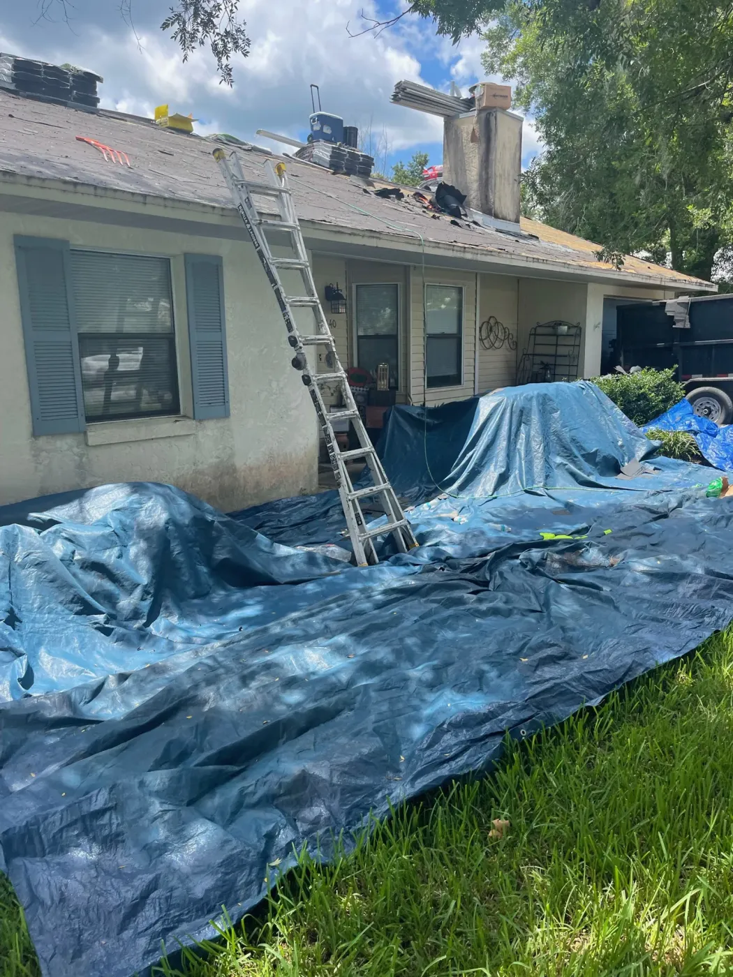 Asphalt Shingle Reroof Property Protection in Dunnellon, FL Property protection during asphalt shingle reroof near chimney by Sentinel Roofing in Dunnellon, FL