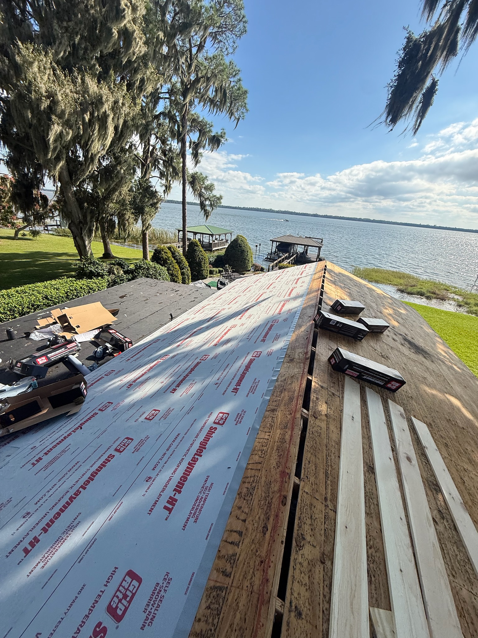 A roof replacement in progress overlooking the lake.