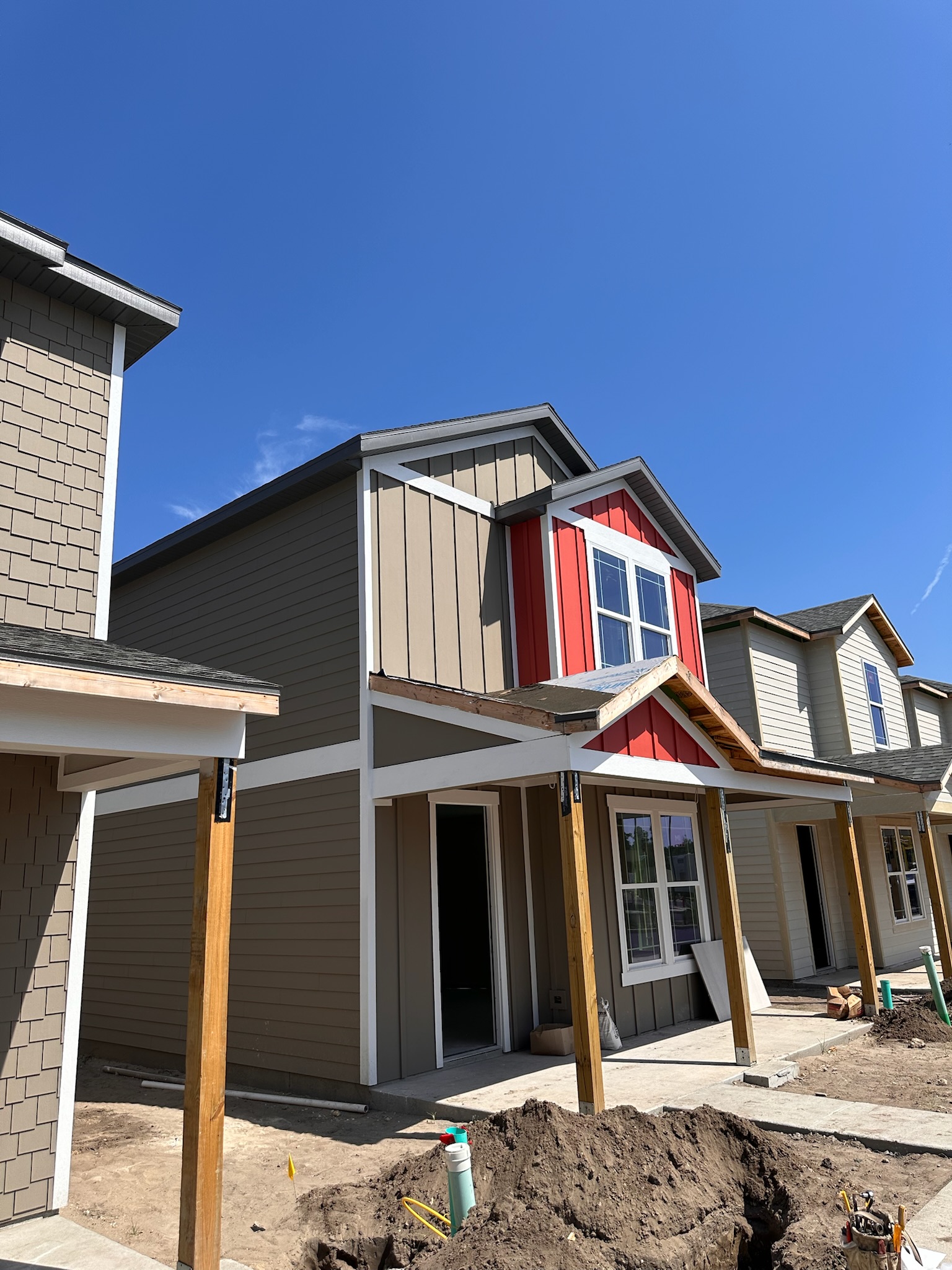 A multifamily property with various colors of siding and new roofing installed by Sentinel Roofing.