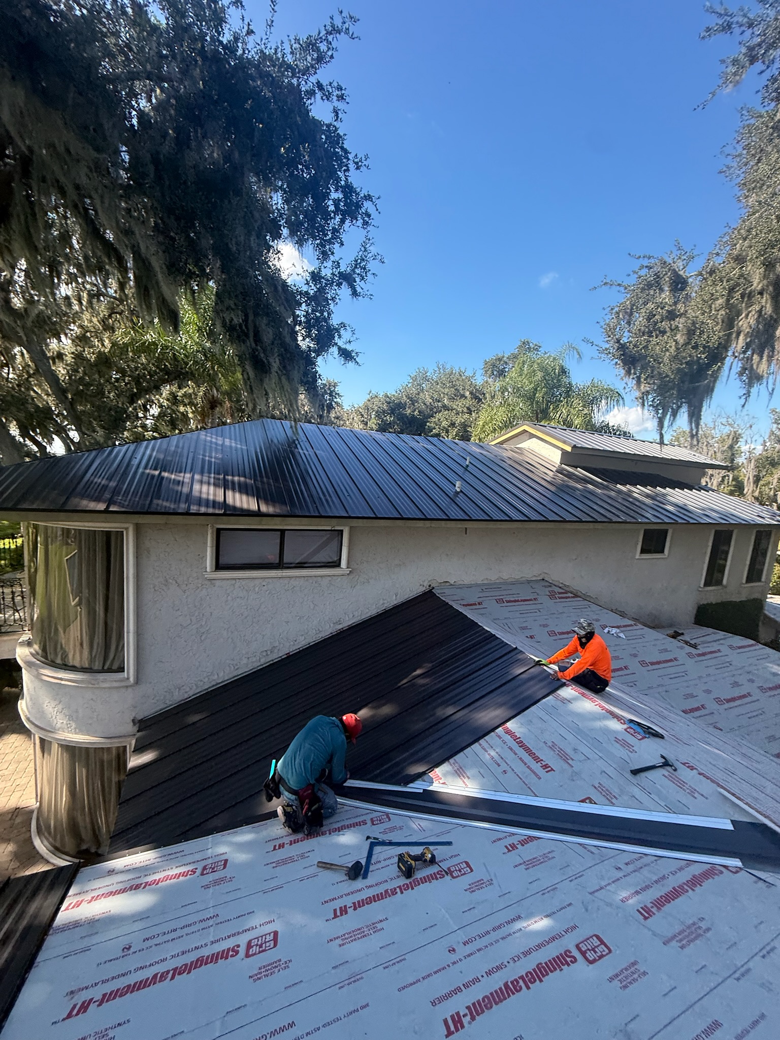 A standing seam metal roof installation in progress by Sentinel Roofing.