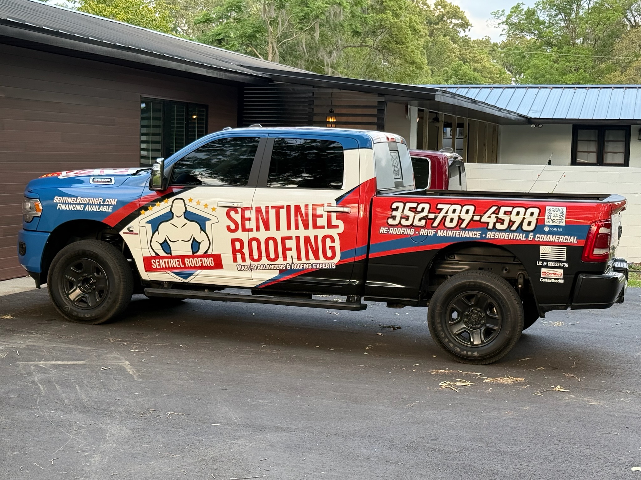 The Sentinel Roofing-branded truck.