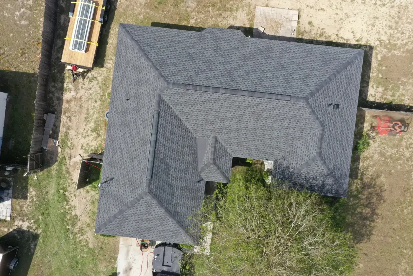 Incredible Residential Roofing | Crystal River, FL | Sentinel Roofing An overhead aerial view captures high-quality residential roofing with freshly installed grey shingles spanning the entire home.